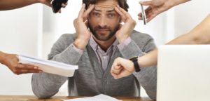 A cropped shot of a handsome businessman under strain as colleagues request various things from him